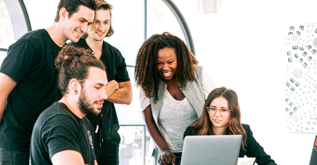 pessoas diversas em empresa olhando para computador